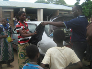 A beneficiary receiving her cloth from Aaron