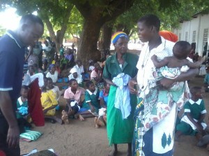 A mother receiving a cloth for her child