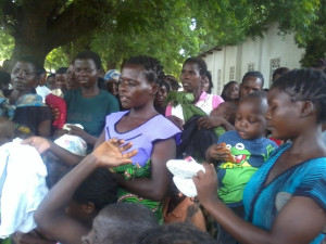 A woman showing a pair of shoes for her child